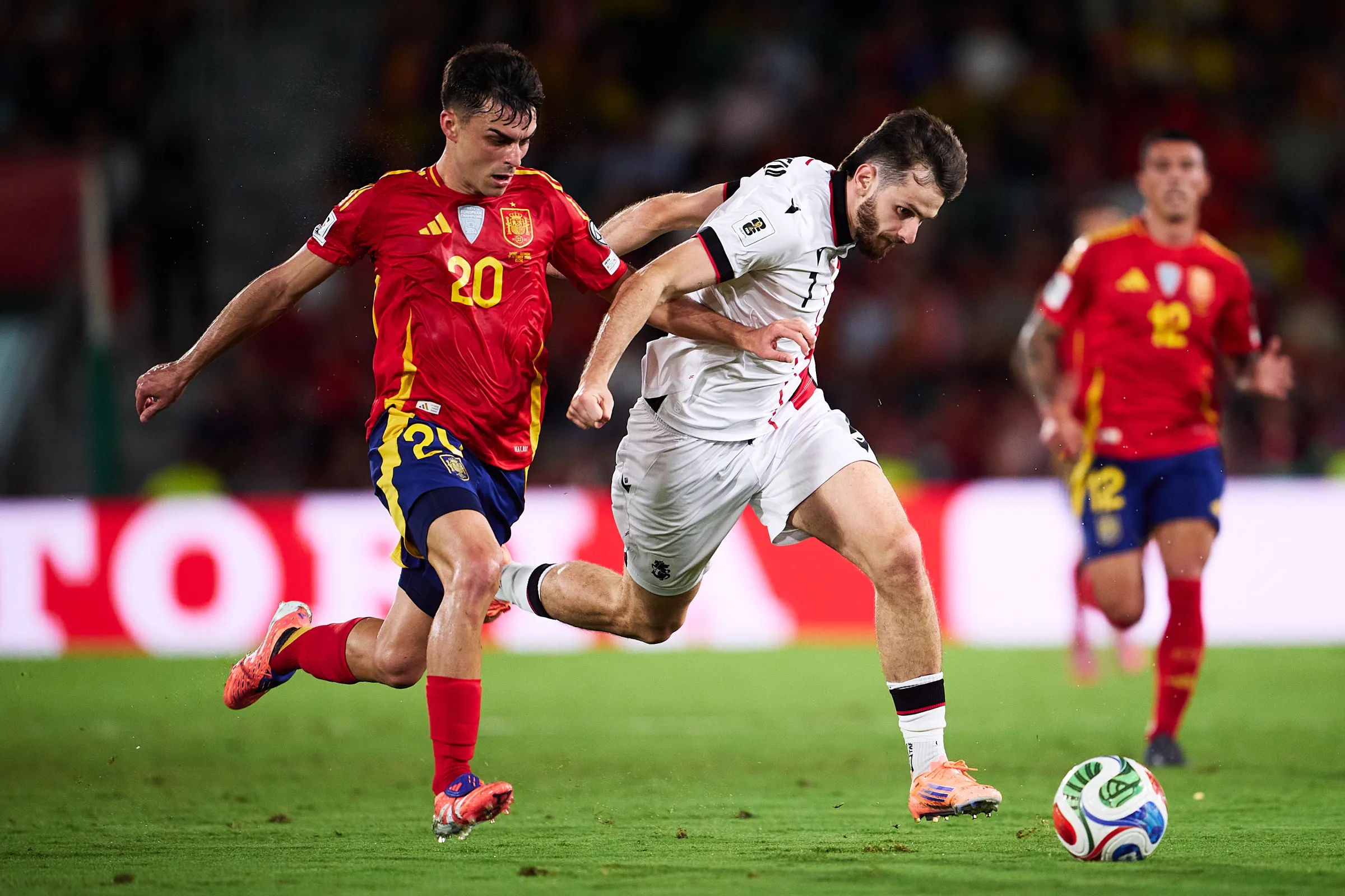 This is it. The fixture that truly separates the dreamers from the realists in World Cup Qualifying Group E. Tonight, under the floodlights of the Boris Paichadze Dinamo Arena in Tbilisi, the Crusaders of Georgia face the titans of Spain. For Spain, this is a business trip; a chance to slap a perfect seal on their qualification campaign and book their tickets to the 2026 World Cup with a game to spare. For Georgia? This is a national event, a moment of pure, desperate hope fueled by the genius of one man and the deafening roar of a fervent home crowd.If you’re a football fan, you have to appreciate this dynamic. It’s not just about the quality gap—it’s about heart versus history. It's about a team that plays with the weight of expectation on its shoulders against a team that has nothing to lose and everything to gain. We’re talking about one of the most dominant sides in world football marching into a passionate, unpredictable cauldron. You can't help but feel that gut-wrenching anticipation. Will Spain cruise, or will Georgia manage the monumental upset that sends shockwaves across the continent?A Sanguine Story: The Georgia vs Spain Head-to-Head HistoryLet’s not mince words: when we look at the Georgia vs Spain head-to-head, it reads like a Spanish travelogue of dominance. La Roja has been virtually flawless against the Crusaders since 2012.The [Georgia vs Spain head-to-head record] stands at a daunting 8 wins for Spain, 1 for Georgia, and 0 draws across their nine historical meetings. That single Georgian win? A shock 1-0 friendly victory back in 2016. In competitive matches, the dominance is brutal. Just look at the Euro 2024 qualifying campaign: a stunning, yet sobering, 7-1 demolition in Tbilisi, followed by a 3-1 win in Spain.More recently, in the reverse fixture of this very World Cup campaign last month, Spain earned a professional, but highly dominant, 2-0 victory. Georgia barely got a sniff of the ball that day. Over their last five meetings, Spain has won them all, scoring 16 goals and conceding only three. History tells us this is a foregone conclusion, but the beauty of football is that it only takes one moment, one flash of brilliance, to rewrite the script. The sheer magnitude of an upset tonight would be remembered forever.La Roja’s Flawless Run vs. Georgia’s Fragile Defence: Recent Form & Key StatsIf you wanted to see the statistical chasm between these two sides, you just need to glance at the Group E table.[Georgia vs Spain stats] at a Glance (World Cup Qualifiers):MetricSpain (1st Place)Georgia (3rd Place)Pld / Points4 / 124 / 3Goals Scored156Goals Conceded09Goal Difference+15-3Clean Sheets4 (out of 4)1 (out of 4)Spain’s form is, quite simply, immaculate. They have a 100% winning record in the group and a zero goals conceded statistic that is frankly terrifying. Their recent 4-0 dismantling of Bulgaria and the preceding 2-0 win over Georgia show a side that is ruthless, efficient, and defensively unbreakable. Luis de la Fuente has created a team that not only controls possession, but knows exactly how to transition that control into goals, averaging an eye-watering 3.75 goals per game.Georgia, on the other hand, comes into this game having lost three of their four qualifiers. Their sole victory was a solid 3-0 home win against bottom-side Bulgaria, but recent losses to Turkey (3-2 and 4-1) and the reverse loss to Spain expose a worrying defensive fragility. They concede an average of 2.25 goals per game. The form guide screams "Spanish Victory," but this is Tbilisi, and they’ll be scrapping for every single blade of grass.The Midfield Missing Pieces: Team News & Key PlayersBoth sides are dealing with notable absences, which definitely injects some unpredictability into the tactical setup.For the visitors, Spain is missing some colossal names, which should give Georgian fans a tiny boost of hope. Rodri, the sensational defensive midfielder, is sidelined, as is the electric winger Nico Williams. The headline absence, however, is the talented youngster Lamine Yamal, who has withdrawn due to a groin issue that Barcelona are clearly managing carefully. Even with these injuries, De la Fuente’s squad depth is obscene, with the likes of Mikel Merino stepping up brilliantly. Merino has been a goal machine from midfield, and his battle with the deep-lying Georgian pivot will be a huge factor.For Georgia, the situation is more concerning. They are without two huge pieces: the influential Villarreal striker Georges Mikautadze due to injury, and key midfielder Giorgi Kochorashvili due to a suspension after picking up two yellow cards in previous fixtures. Losing Mikautadze, a primary goal threat, severely limits their already thin attacking options.The entire Georgian plan will revolve around one man: Khvicha Kvaratskhelia. The Napoli star is the creative heartbeat, the only player capable of moments of world-class magic. Spain will absolutely double-mark him, likely using the experienced full-back Marc Cucurella and a covering midfielder. If Kvaratskhelia can beat the double-team and create just one or two big chances, he could shock the world.Predicted Lineups: Control vs. CounterDespite the absences, expect De la Fuente to stick to the trusted 4-3-3 shape, focusing on control and pressing. Georgia will be forced into a highly pragmatic, defensive 5-3-2 or 5-4-1.🇪🇸 Spain (4-3-3 Formation)Goalkeeper: Unai SimónDefenders: Pedro Porro, Robin Le Normand, Pau Cubarsí, Marc CucurellaMidfielders: Mikel Merino, Martín Zubimendi, Fabián RuizForwards: Mikel Oyarzabal, Ferran Torres, Álex Baena🇬🇪 Georgia (5-3-2 Defensive Formation)Goalkeeper: Giorgi MamardashviliDefenders: Solomon Kvirkvelia, Guram Kashia (C), Luka Lochoshvili, Otar Kakabadze, Iraklı AzaroviMidfielders: Giorgi Chakvetadze, Nika Kvekveskiri, Jaba KankavaForwards: Khvicha Kvaratskhelia, Budu ZivzivadzeTactical Chess: What to Expect on the PitchSpain's plan is obvious: sustain pressure until the dam breaks. They will dominate possession, likely holding close to 80% of the ball, using short, sharp passing to drag Georgia’s compact lines out of shape. The key is in the full-backs, Porro and Cucurella, who will push high to provide the width, allowing the wide forwards (Oyarzabal and Baena) to drift inside and link up with Ferran Torres. Spain will hunt in packs, looking to win the ball back instantly after any loss.Georgia’s entire strategy is survival and opportunism. Coach Willy Sagnol has to hope that his keeper, Mamardashvili, is having a career-defining game. The back five will be deep, narrow, and disciplined, protecting the penalty area. Their one, single out-ball will be the transition play, hoping a long pass can find Kvaratskhelia or Budu Zivzivadze isolated one-on-one with a Spanish defender. If they can hold out for an hour, the tension might just start to get to the Spanish players, but scoring a goal themselves against this Spanish defence feels like climbing Everest in flip-flops.The Thunder in Tbilisi: Fan Perspective and AtmosphereForget the stats for a second. This is where football lives. The atmosphere in the Dinamo Arena will be absolutely primal. Georgian fans are among the most passionately loyal in Europe. They know the odds, but they believe in the impossible. They’ve seen Kvaratskhelia do the unthinkable for Napoli, and they’ll be clinging to the hope that he can reproduce that magic for the national side.Social media is a mix of realism and raw emotion. For the Spanish faithful, it's about getting the job done, securing the three points, and avoiding injury. For the Georgians, it's about pride. "Even if we lose," one fan wrote, "we must show them our heart. Make them fight for every single minute." Ticket demand has been astronomical—a chance to witness their greatest player against one of the world's greatest teams. Expect a deafening welcome for La Roja, designed to unsettle their usually cool, calculated approach. That atmosphere might just be Georgia's 12th man.📺 Where to Watch Georgia vs Spain LiveDon’t miss this vital World Cup Qualifier! The action kicks off on Saturday, November 15, 2025.Where to Watch Georgia vs Spain Live StreamFans in the UK can watch the Georgia vs Spain live stream on Amazon Prime Video PPV, while US fans can stream the action via Fubo and ViX.Here’s where to watch the match online and on TV in key regions:RegionTV Channel / StreamKick-off TimeUKAmazon Prime Video (PPV)5:00 PM GMTUSAFubo, ViX12:00 PM EST / 9:00 AM PSTSpainTVE (TBC)6:00 PM CETGeorgia1TV (TBC)9:00 PM GETTo find the specific broadcast in your region, searching "where to watch Georgia vs Spain" is your best bet. Make sure you check local listings for the most accurate information on the [Georgia vs Spain live stream] options!🔮 The Final Verdict: Georgia vs Spain PredictionAs a football fan, I’m rooting for chaos, noise, and a moment of Kvaratskhelia magic. But I have to be honest with my [Georgia vs Spain prediction].Spain is too disciplined, too talented, and too clinical to drop points here. Their perfect defensive record is the real killer for Georgia's hopes, especially with Mikautadze and Kochorashvili missing. Georgia will fight like lions in the first half, perhaps holding them scoreless for 30 or 40 minutes, but the sustained pressure, coupled with the individual brilliance of players like Merino and Oyarzabal, will eventually find a crack in that Georgian wall.It won't be another 7-1, but Spain will dominate and get the result they need.Match Prediction: Georgia 0 - 3 SpainThe Heart of the GameWe watch football because of nights like this. Even when the odds are stacked so heavily against the underdog, there’s always that flicker of hope—that one-in-a-million chance that the collective human spirit can triumph over cold, hard statistics. Tonight, Georgia carries that spirit. Spain is playing for the World Cup; Georgia is playing for pride and a memory.May the best team win, but may the atmosphere be unforgettable! ¡Vamos España! and Forward, Georgia!